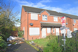 This house on Dawson street was left empty following a fire. The driveway has become a dumping ground