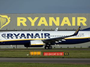 Ryanair plane seen in profile before a Ryanair hangar