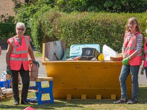 Volunteers filling a skip at Saturday’s ‘Be Proud Of Your Community Day’.
