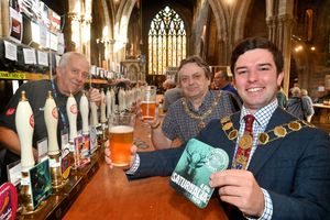 SHREW COPYRIGHT NATIONAL WORLD STEVE LEATH 24/09/25St Mary the Virgin Church in Shrewsbury, and the 2025 Beer Festival has arrived. In the suit and chains is Mayor: Alex Wagner, blue shirt and chains is Landlord of The Bailey Head Pub and Chair of Shropshire Council: Duncan Borrowman, and with them from the festival is: Dave Ricketts. The pump clip they head is from the Shropshire ales blind taste test and is Saturnalia Porter by Stonehouse Brewery.