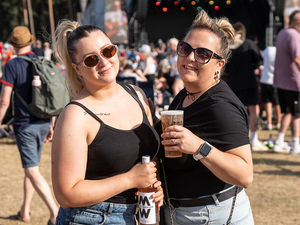 Friends enjoying a drink, the sunshine and the music