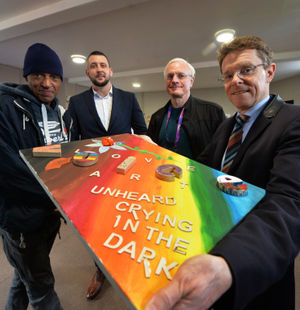 Service user Darren Parkes, CEO Tom Hayden, former Wolves player Mel Eves, and Mayor of the West Midlands Andy Street pose with one of the artworks