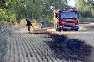 Firefighters damp down after the fire by the M6