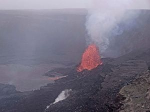 A fountain of lava shoots up from the latest episode of an ongoing eruption of a volcano in Hawaii