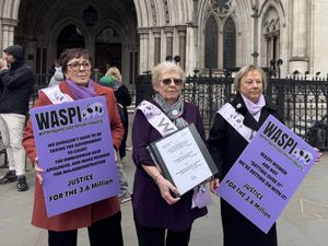 Waspi campaigners with placards outside the Royal Courts of Justice in London