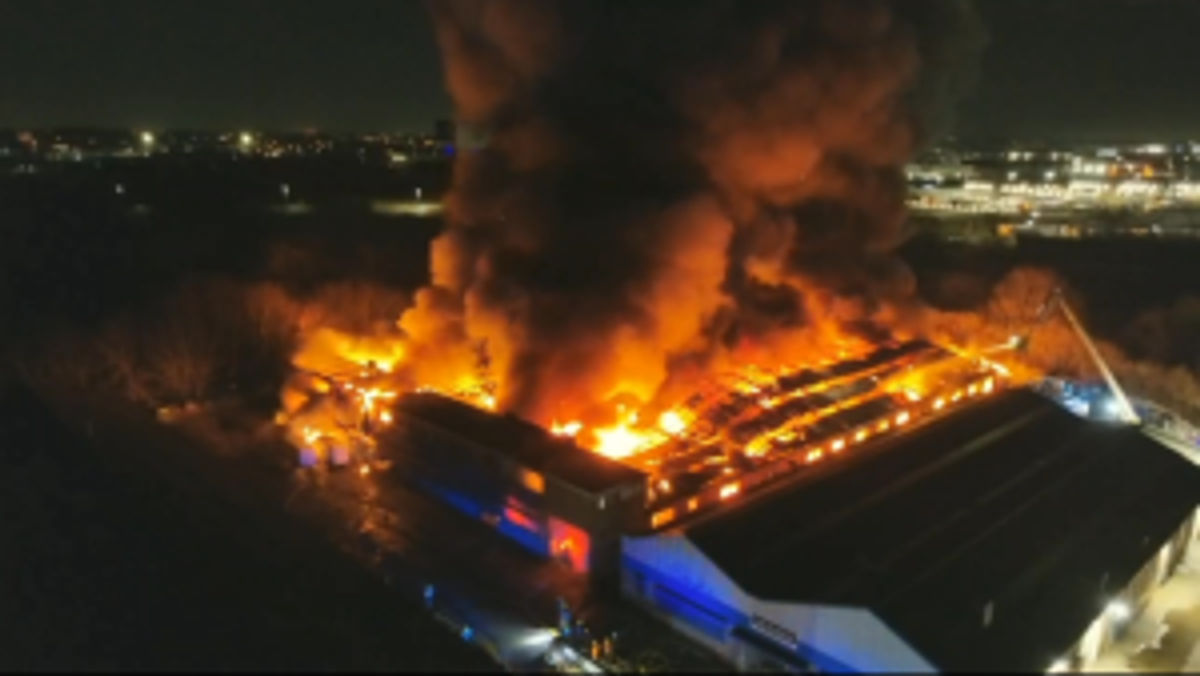 Smoke cloud seen for miles and residents told to keep windows closed as fire crews battle huge blaze at Birmingham carpet storage unit