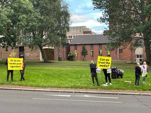 The anti-vaxxers holding signs on the A4150. Photo: Aaron Humphriss