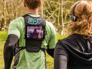 Supporting image for story: This gym will let you watch TV via a tablet strapped on a trainer’s back while you run
