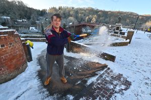 Dr Peter Burnett helps a neighbour clear his drive. Photo: Steve Leath