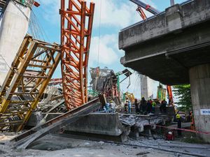 Thai rescue workers work the scene after an elevated road being built collapsed in Bangkok