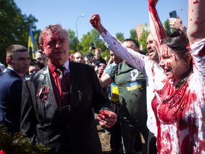 Supporting image for story: Russian ambassador to Poland hit with red paint by protesters
