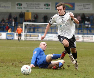 Telford's Lee Moore takes the ball past Jon Hawley.