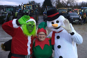 The Grinch – Peter Bayliss, elf Mel Lloyd and the snowman, Steve Lloyd, were a great attraction at the start of the tractor run. Image by Andy Compton