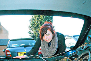 Louise Bradley surveys the damage to her car after a section of Ludlow Town Walls collapsed onto it in 2013