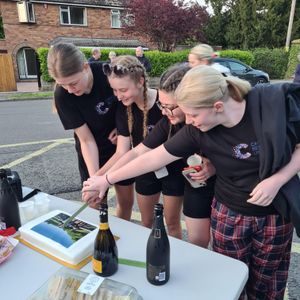 The teens were welcomed over the finish line by a group of family, friends and school staff