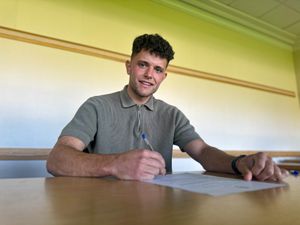 Charlie Williams signs his contract for Telford. 