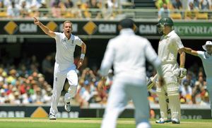 England's Stuart Broad (left) celebrates taking the wicket of Australia's Chris Rogers (right)