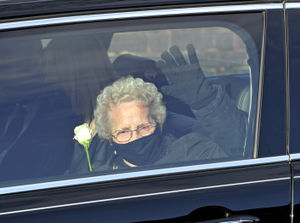 Doris' sister Lil Cox holds a white rose as the end of the service