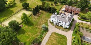 Beech House boasts more than 3.4 acres of land, a tennis court, and a separate red brick barn. Picture: Rightmove/Peter James Property Ltd.