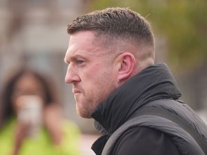 Side view of Tommy Robinson outside Folkestone police station in October 2024