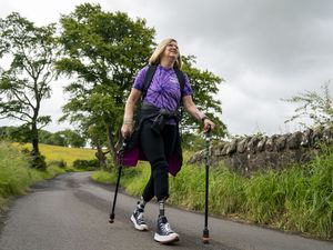 Cor Hutton walking with poles down a country lane