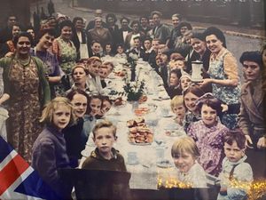 A street party to mark the end of fighting in Europe held in Hollyhedge Road, Walsall. Holding the jug was 20-year-old Florence Aldridge, while wearing the green cardigan opposite was her mother Elizabeth Mountford. Just behind her, in the green pinafore dress, is Elizabeth's other daughter, Gwendoline, and the white-haired figure just visible at the very back was Elizabeth's mother, only known as Mrs Peakman. The young girl, third from front on the right, is Florence's niece Beryl Mountford. The picture was supplied by Florence's son Philip Aldridge, who lives in Wednesfield, Wolverhampton.