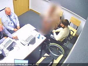 Triple killer Kyle Clifford is pictured in a wheelchair being interviewed by police