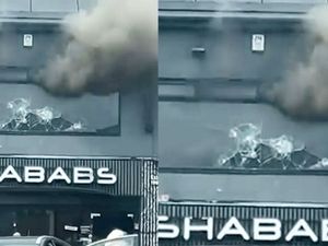 Supporting image for story: West Midlands: Dramatic moment hero passersby hurl rocks at window of burning building to free staff