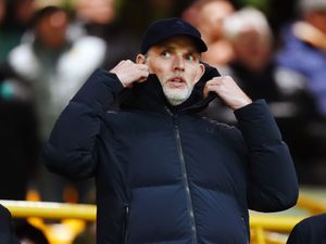 Thomas Tuchel with his hands on his coat collar