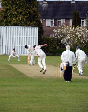 Oswestry's Dan Bowen bowls to Walsall's Tim Maxfield.