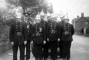 Market Drayton fire brigade in Buntingsdale Road in about 1930, complete with their open fire appliance and brass helmets. Charlie Sillitoe is on the right, and his father Henry is believed to be far left.