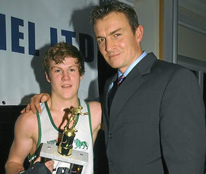 Richie Woodhall presents Dylan, then 16, with a boxing trophy  