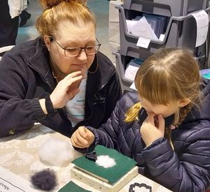 Samantha Loughlin of Mum's Makery teaches needle felting to a young enthusiast. 