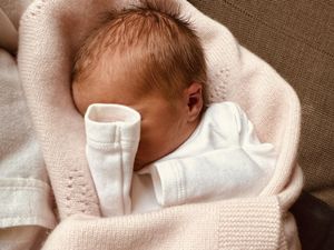 Athena Elizabeth Rose Mapelli Mozzi, daughter of Princess Beatrice and Edoardo Mapelli Mozzi, wrapped in a blanket