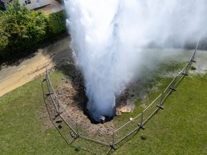 Supporting image for story: Residential street flooded as burst main shoots 100ft jet of water into the air