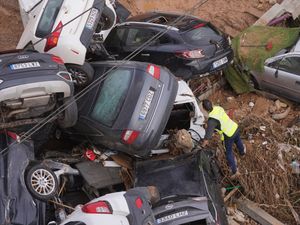 A civil guard searches for survivors in cars piled up on the outskirts of Valencia in Spain