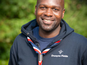 Supporting image for story: Chief Scout Dwayne Fields congratulates local Scouts