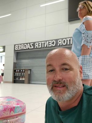 Passenger Chris Smith pictured sitting on airport floor in Zagreb, Croatia. Photo: Chris Smith