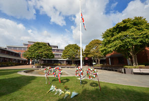 Floral tributes next to the Union flag at half mast, outside Sandwell Council House, Oldbury.