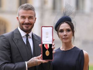 Supporting image for story: Sir David Beckham smiles next to Lady Victoria Beckham after being knighted