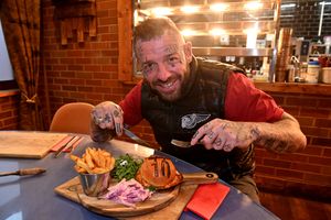 Lockside Steakhouse Stourbridge owner Matt Lemm tucks into the 'Bellingham Burger.' 