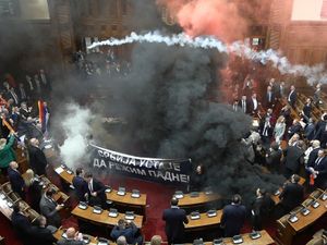 Supporting image for story: At least three Serbian MPs hurt as smoke bombs and flares thrown in parliament