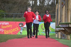 On the school's daily mile running track: Noah, 11, Meryem, 10 and Lesley, 10