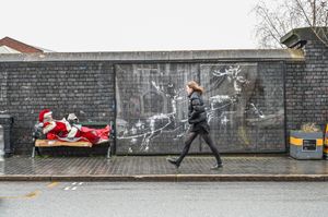 Father Christmas has showed up on a bench in Birmingham's Jewellery Quarter next to the Banksy mural. December 17 2025.