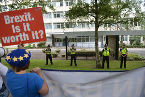 Police officers watched protesters as Prime Minister Boris Johnson arrived at West Midlands Police Learning and Development Centre in Birmingham on Friday