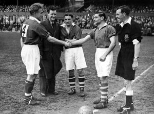 Billy, left, at a benefit match at the Gay Meadow in April 1950, shaking hands with Jackie Butler of Shrewsbury Town, with Wolves' Johnny Hancocks, centre. The benefit was for Jackie and another Town player, Joe Wheatley, who is in the overcoat and was unable to play because of tonsillitis. The referee was Sam Rogers, Shrewsbury's only league referee at the time.
