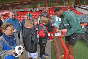 Walsall striker Jamille Matt signs autographs.