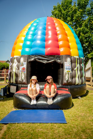 Pupils Cecily and Emily in front of the disco dome at St Kenelm’s Primary School Summer Fayre which was sponsored by local housebuilder Bellway