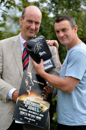 Richie Woodhall, right, and Jeremy Lamond of Halls get ready to auction off the glove signed by boxing legends Joe Calzaghe and Roy Jones Junior