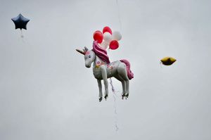 Balloons are released into the sky at Dell Stadium